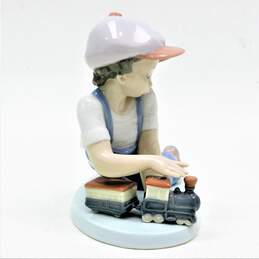 Lladro 7619 All Aboard Porcelain Figurine Boy With Train alternative image