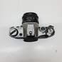 UNTESTED Sliver/Black Canon AE-1 Film Camera Bundle with 3 lenses, Flash & Bag image number 4