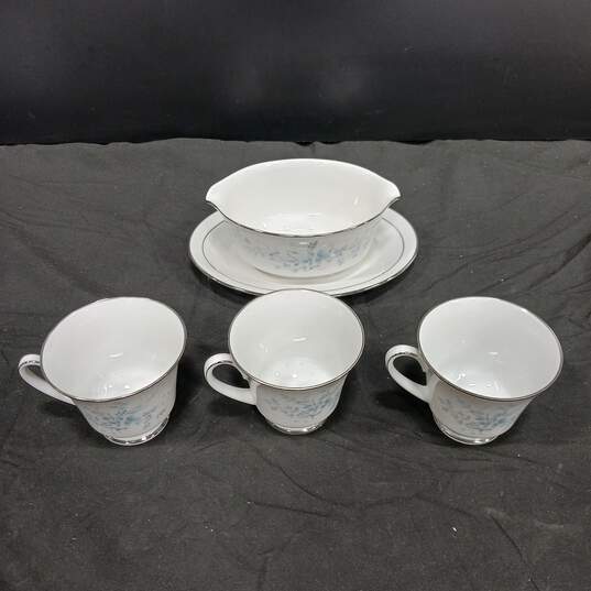 Bundle of Noritake Contemporary Fine China Carolyn Floral White, Blue, And Silver Tea Cups And Gravy Boat With Attached Underplate image number 1