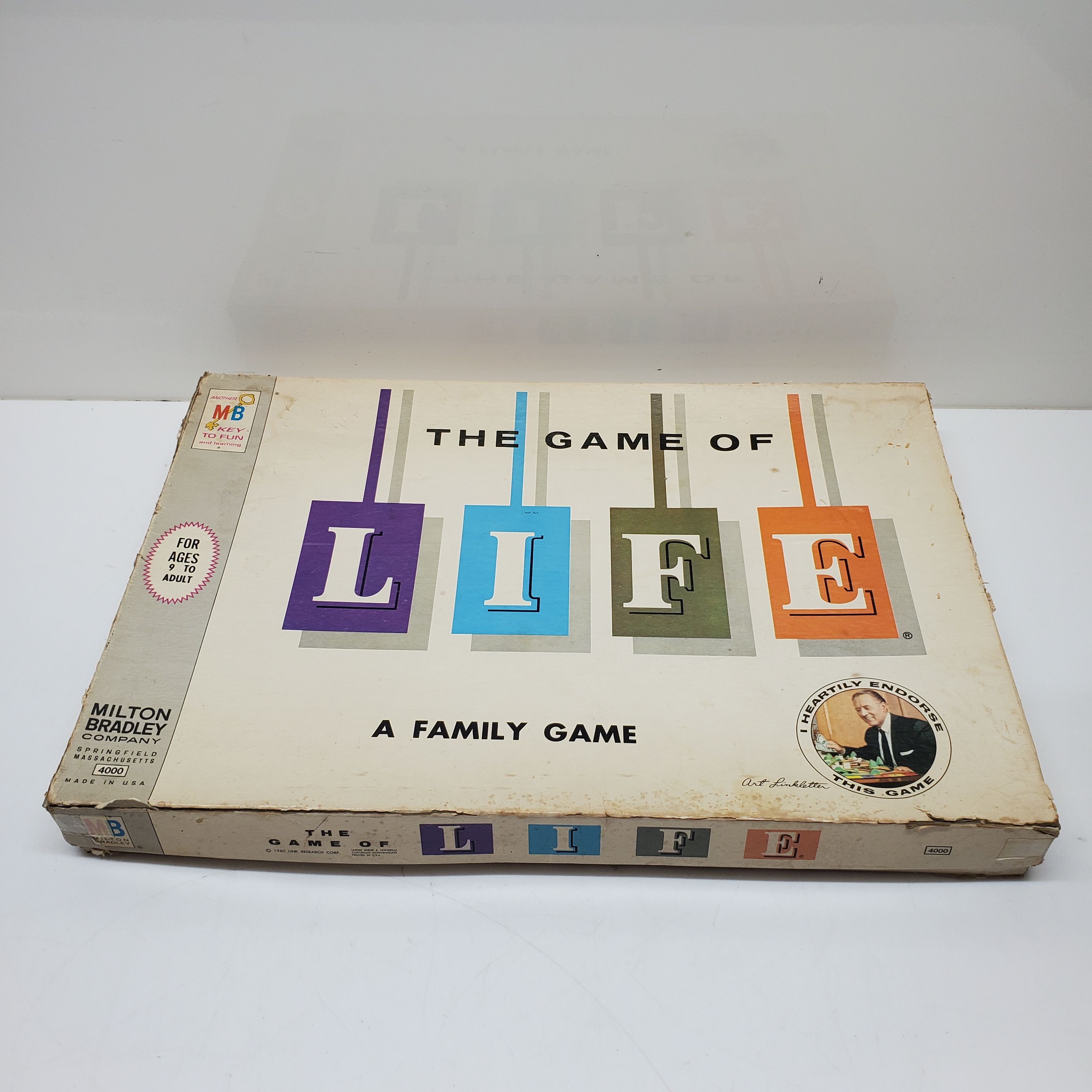 The Game of Life by Milton Bradley. The gameboard & all its