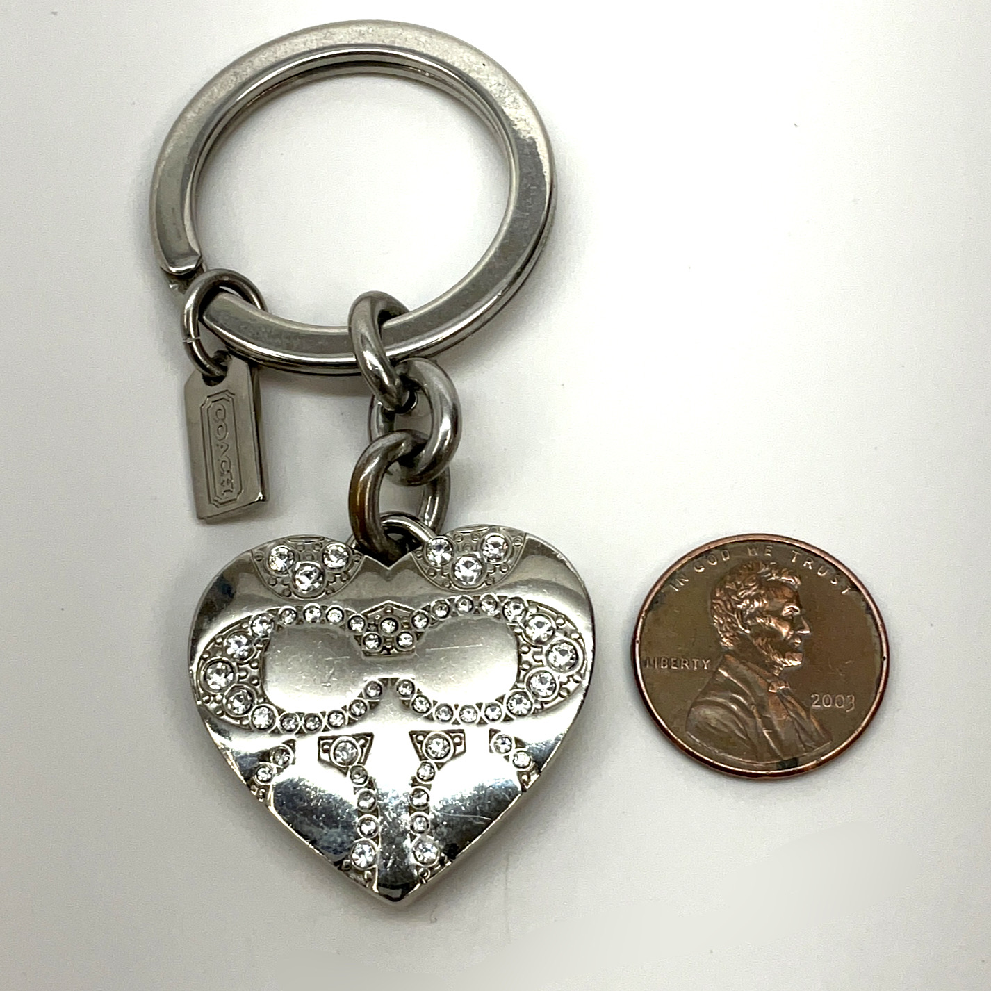 Buy the Designer Coach Silver-Tone Crystal Heart Locket Keychain With Dust  Bag